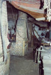 Rear of hoodless forges - Bellows mounted overhead and behind the forges - Anderson Blacksmith Shop, Colonial Williamsburg, Williamsburg, Virginia, USA.