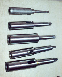 Modified taper shank extensions allow taper shank drill bits to be used