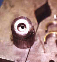 Access hole drilled through center of chuck for removing arbor.